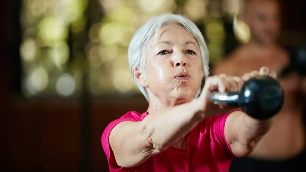 Toning Bingo Wings: Effective Exercises and Tips for Achieving Sleeker Arms 2 Person performing arm exercises with dumbbells Camberley