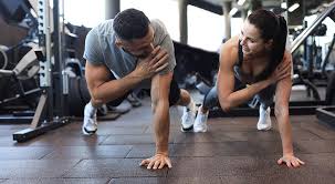 Image of man and woman doing Cardio Camberley to tone their arms. 